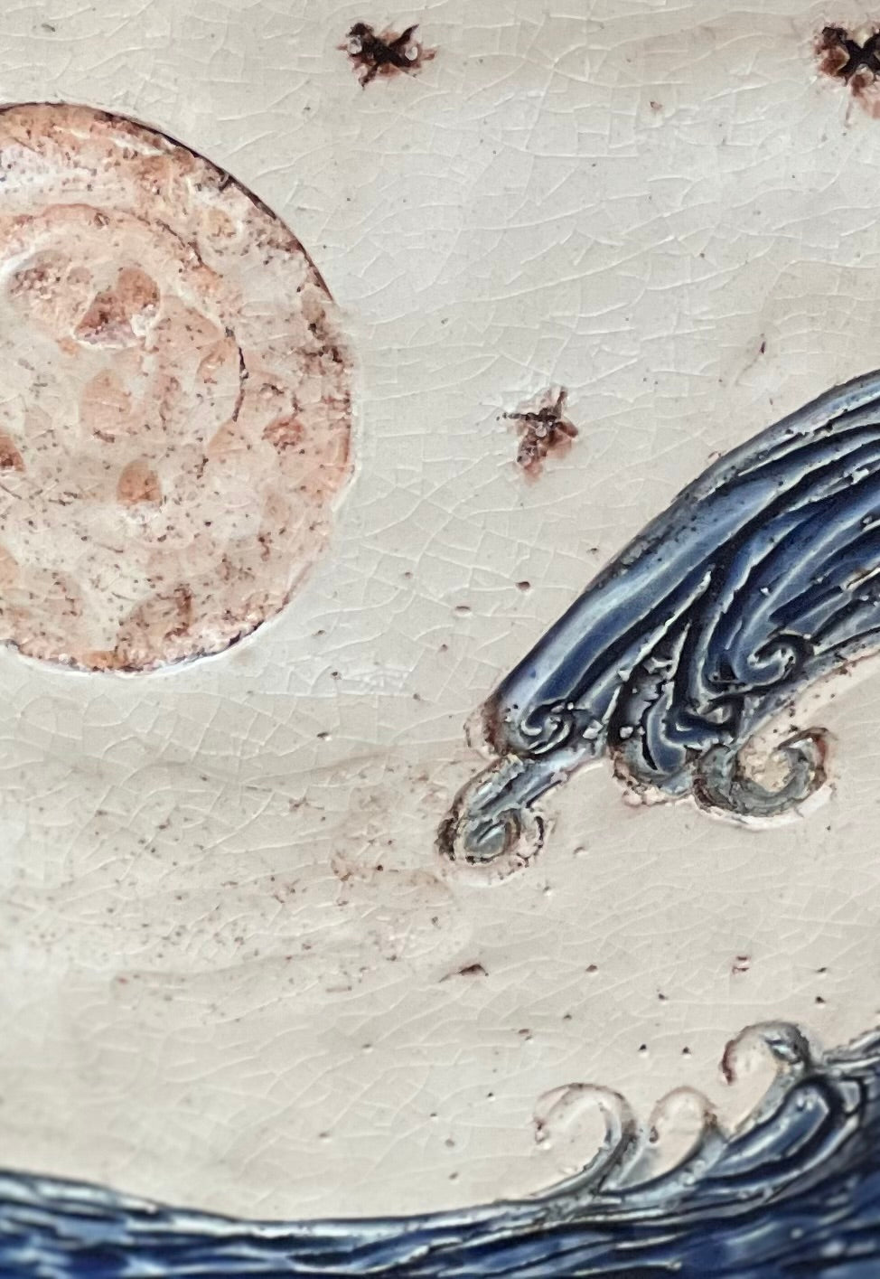 Decorative ceramic pot with wave design and moon on a crackle background