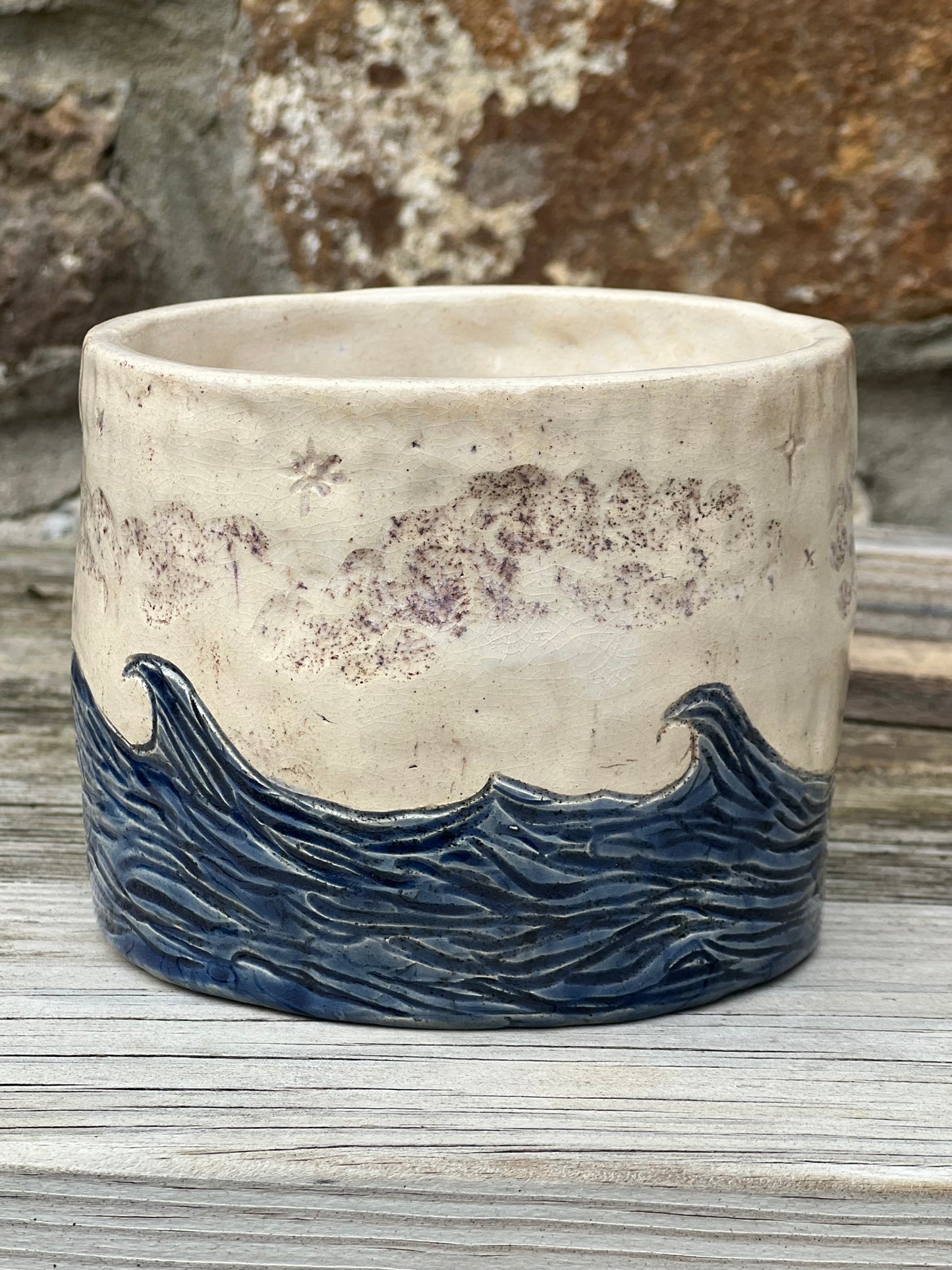Handcrafted stoneware plant pot featuring waves, clouds and stars design